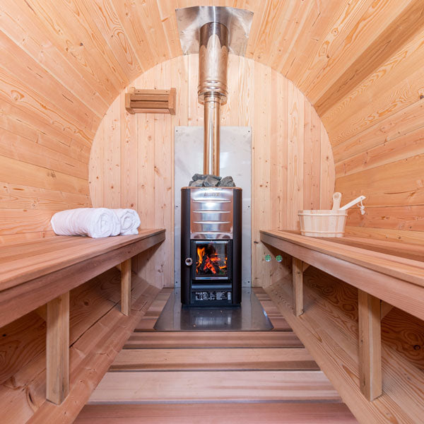Wooden sauna with a stove and benches