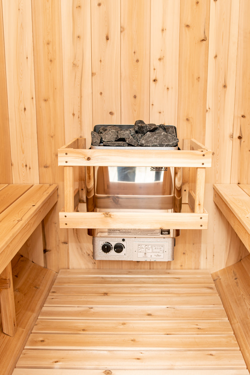 Woden sauna interior with electric stone heater