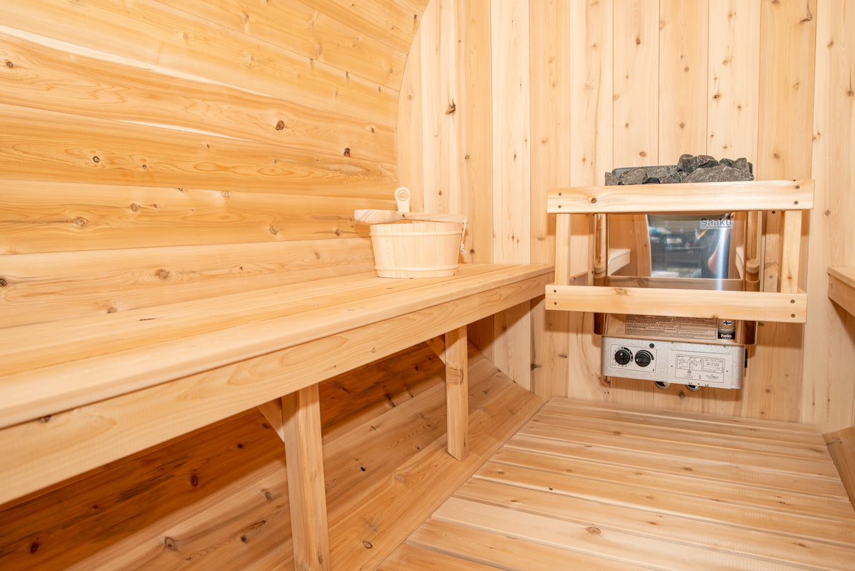 Wooden sauna interior with benches and equipment.