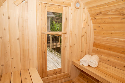 Inside of barrel shape sauna showing door and benches