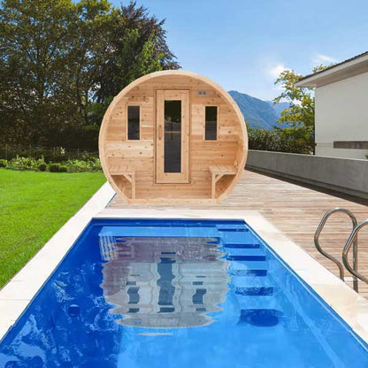 Wooden barrel sauna by a pool with a scenic background