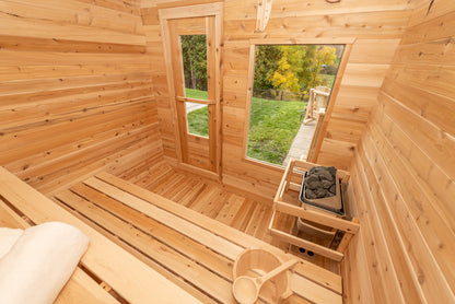 Wooden sauna with benches and a window view of greenery
