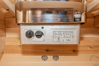 Metallic appliance with control knobs and warning labels on a wooden background