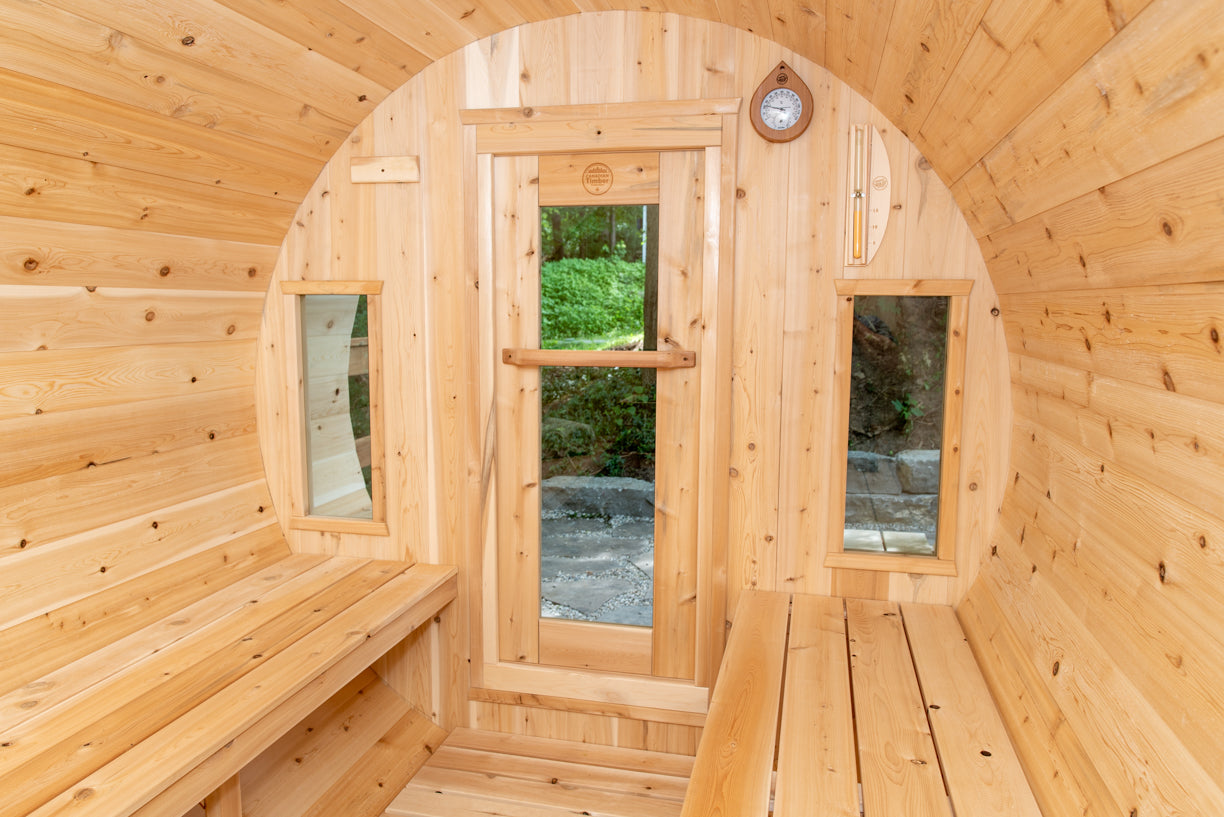Wooden sauna with benches and a glass door