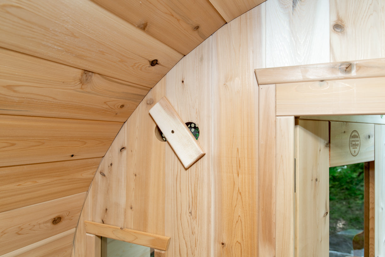 Wooden interior of a curved wall with a small window.