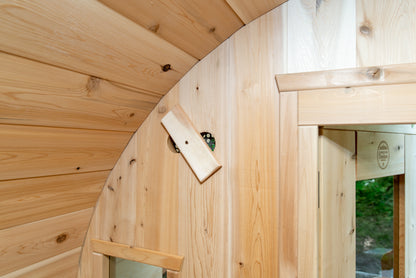 Wooden interior of a curved wall with a small window.