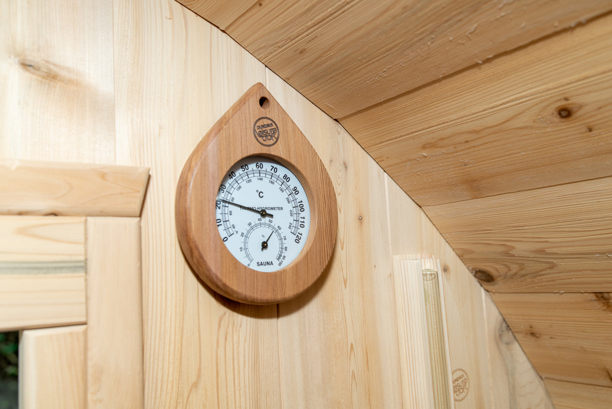 Wooden thermometer on a wooden wall