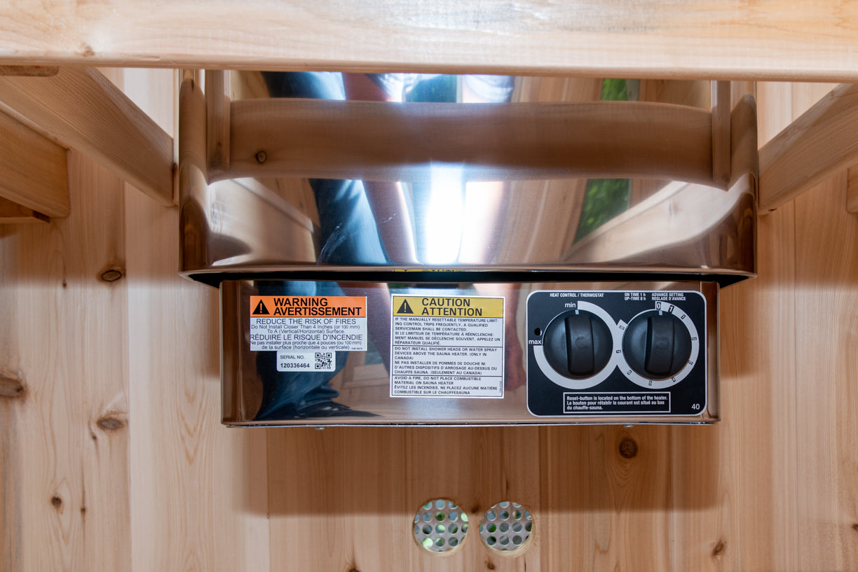 Control panel with warning labels on an electric sauna heater