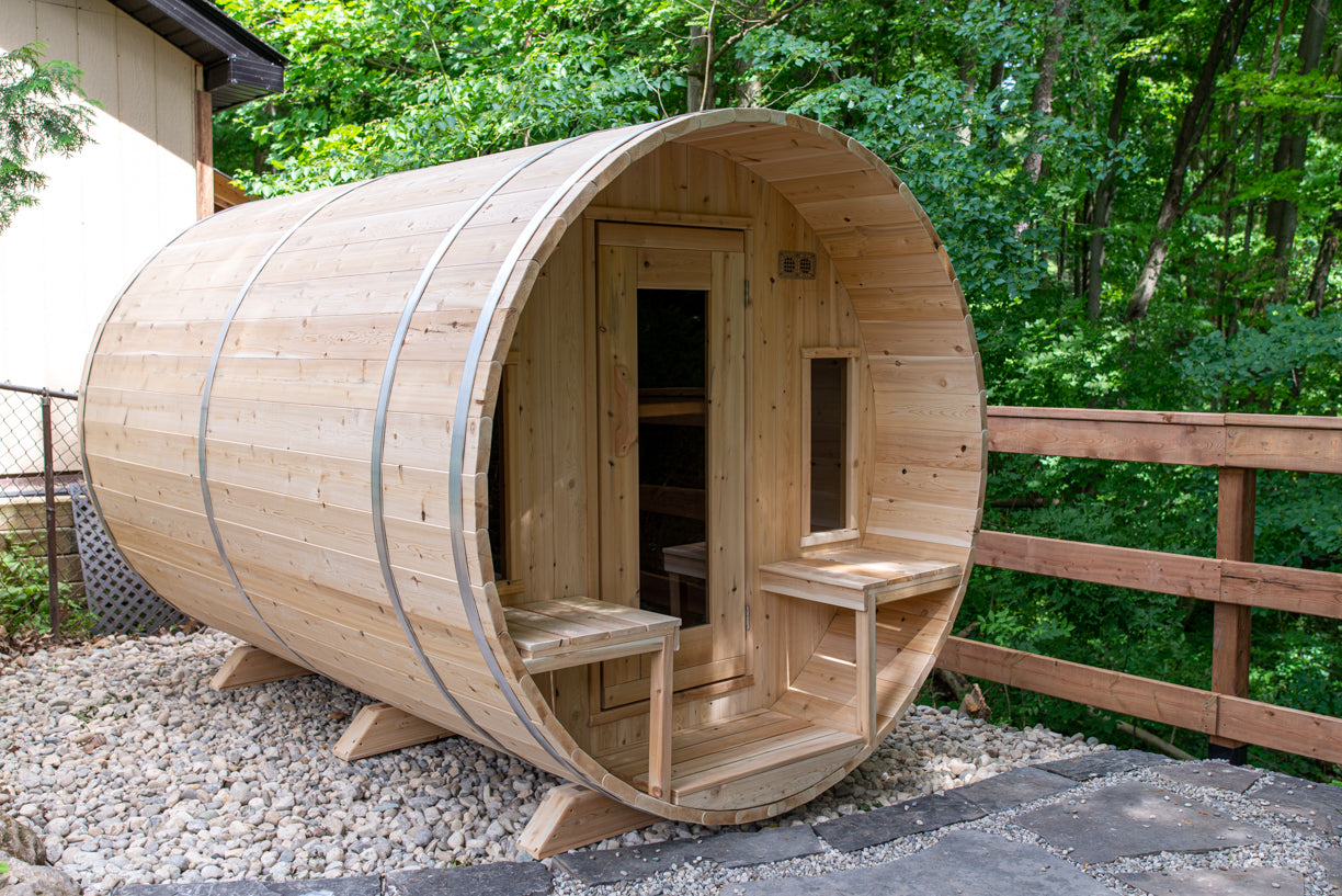 Wooden barrel-shaped sauna in a forest setting