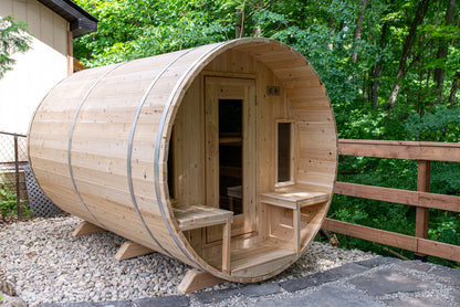 Wooden barrel-shaped sauna in a forest setting
