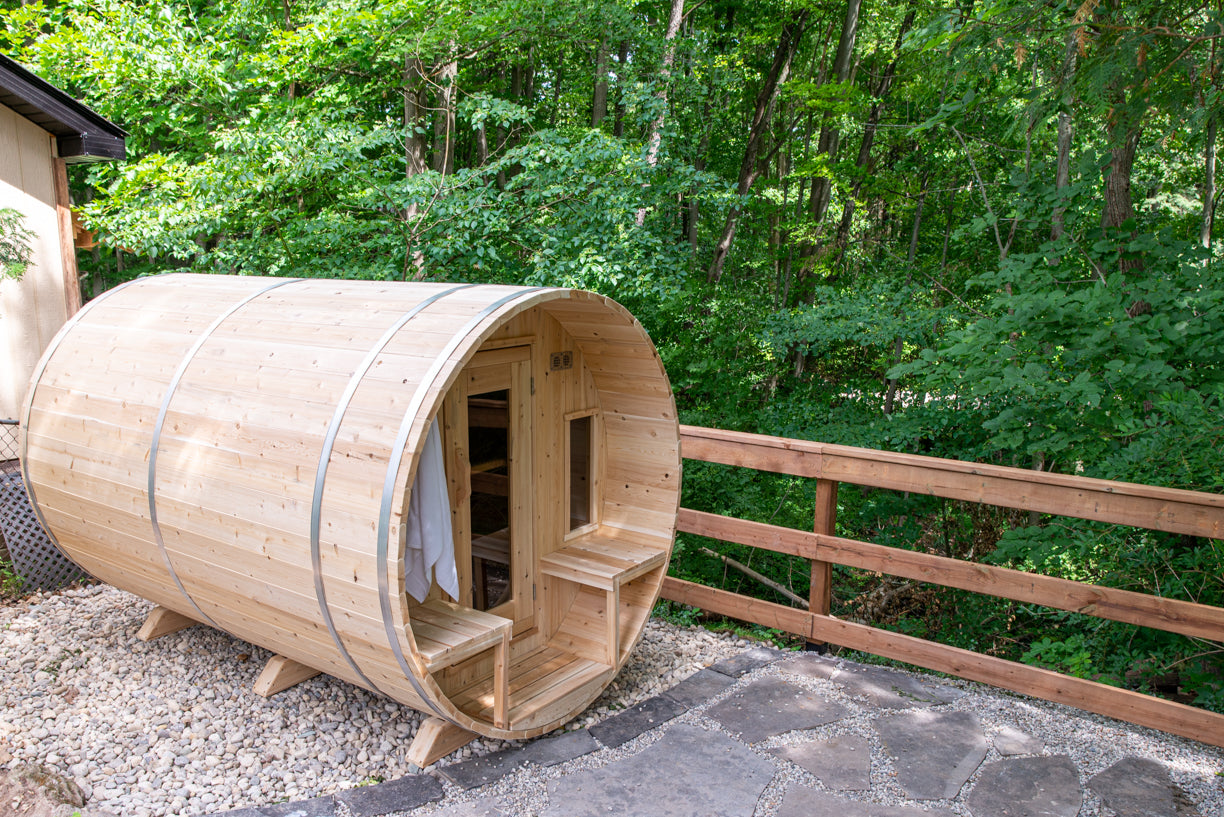 Wooden barrel-shaped sauna in a forest setting