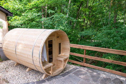 Wooden barrel-shaped sauna in a forest setting
