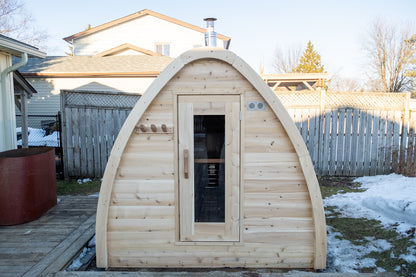Canadian Timber MiniPOD Woodburning sauna in a backyard with snow on the ground