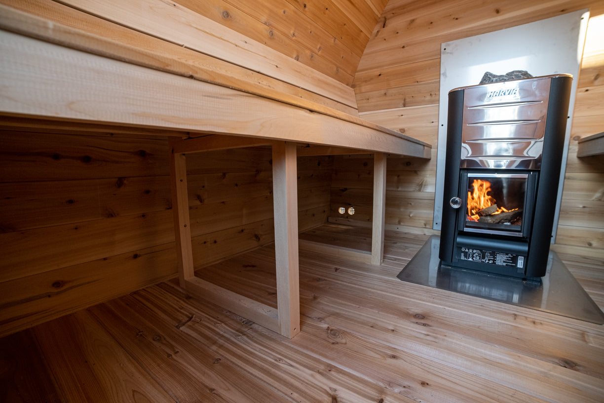 Wooden sauna with a stove and benches