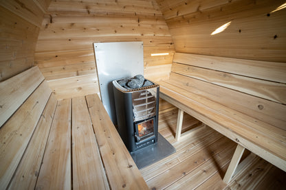 Wooden sauna interior with a stove and benches