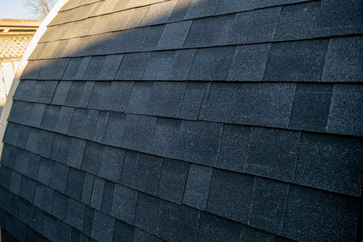 Close-up of a roof with dark gray shingles