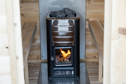 Wood-burning stove in a sauna with flames visible