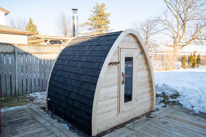 CT MiniPOD Woodburning Sauna by Leisurecraft with an asphalt shingle black roof in a backyard setting with snow