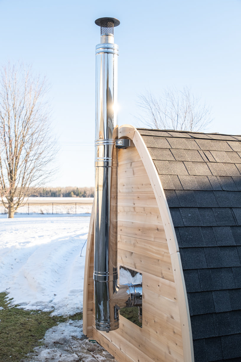 CT MiniPOD Woodburning Sauna by Leisurecraft with a metal chimney pipe against a clear sky.
