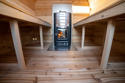 Wooden interior with a stove in the center