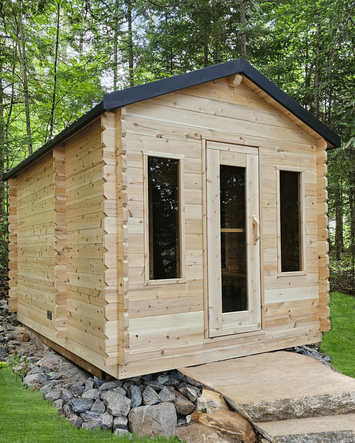 Cabin Sauna with changeroom, two windows and glass in door. 