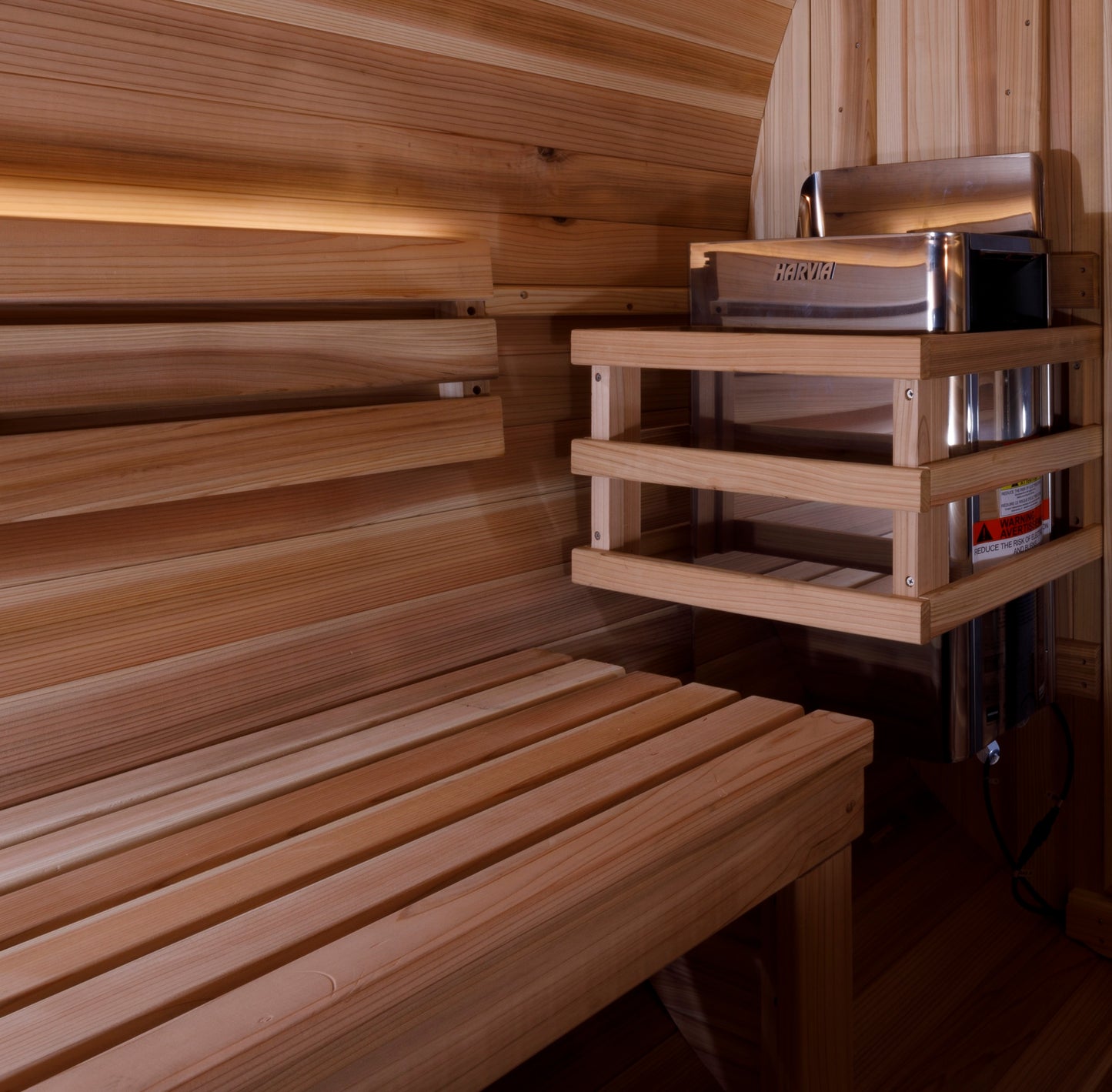 Golden Designs "Zurich" 4 Person Barrel sauna interior pictured showing the electric heater and bench seating