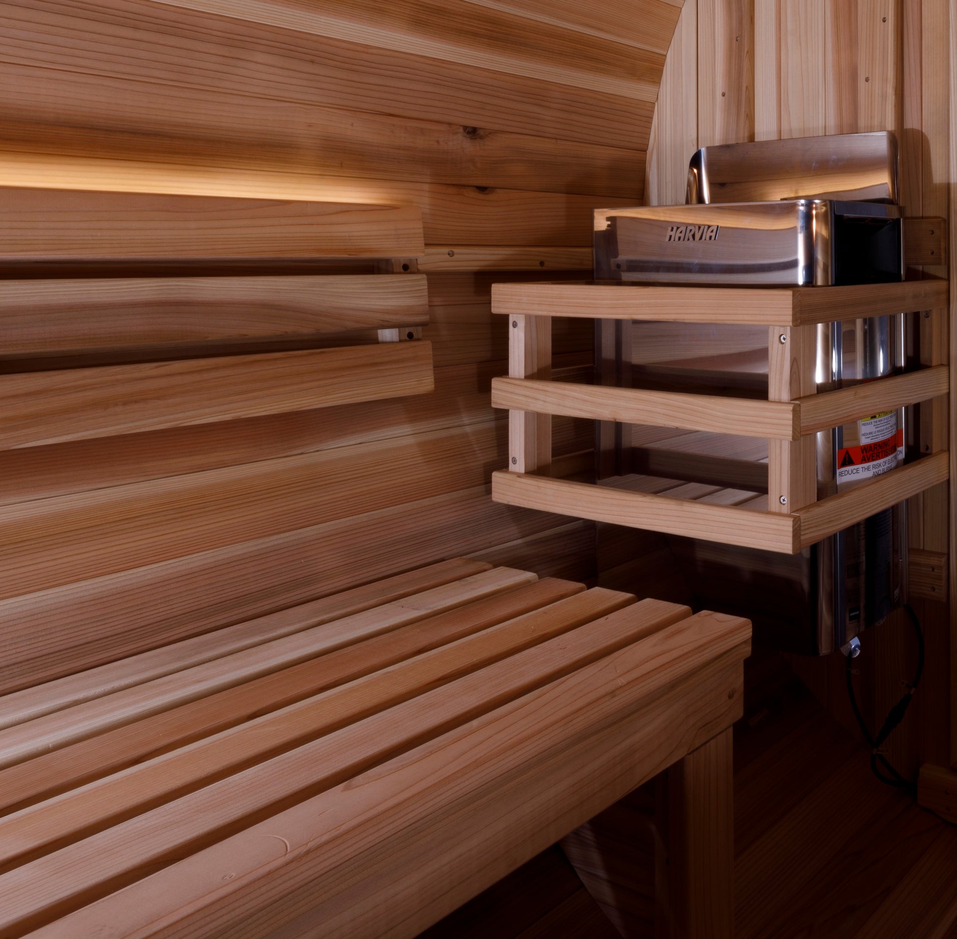 Golden Designs "Zurich" 4 Person Barrel sauna interior pictured showing the electric heater and bench seating