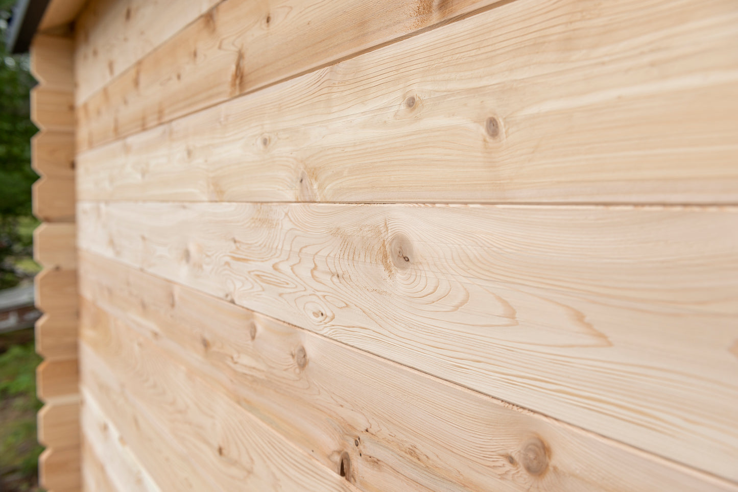 Close-up of a wooden cabin wall with visible grain and texture.