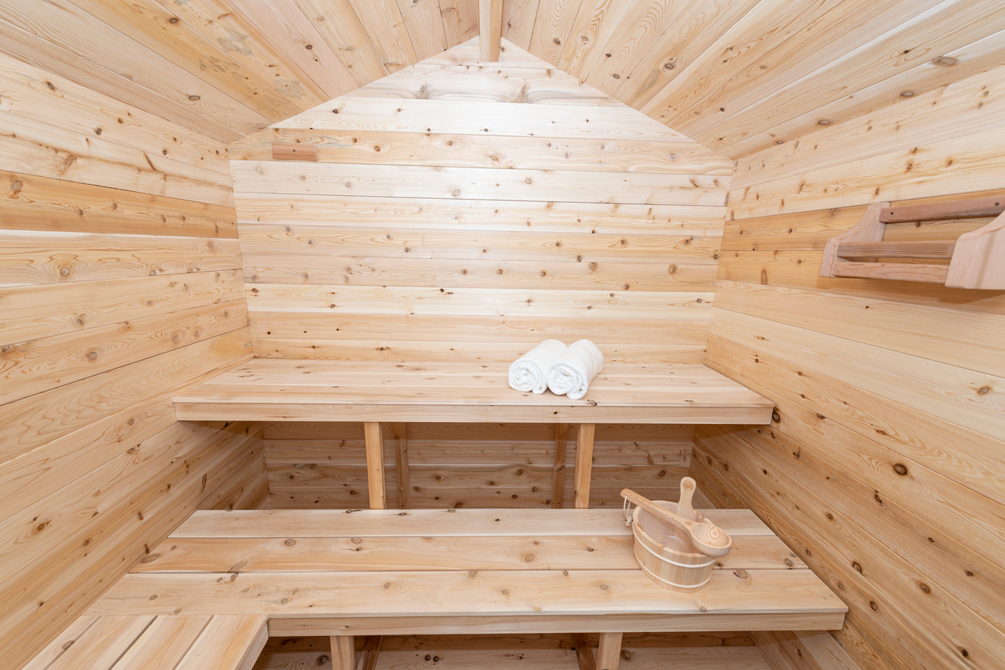 Wooden sauna with benches and towels
