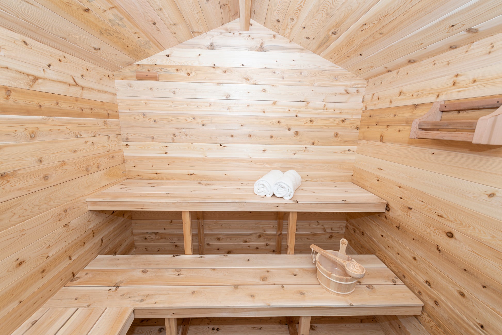 Wooden sauna with benches and towels