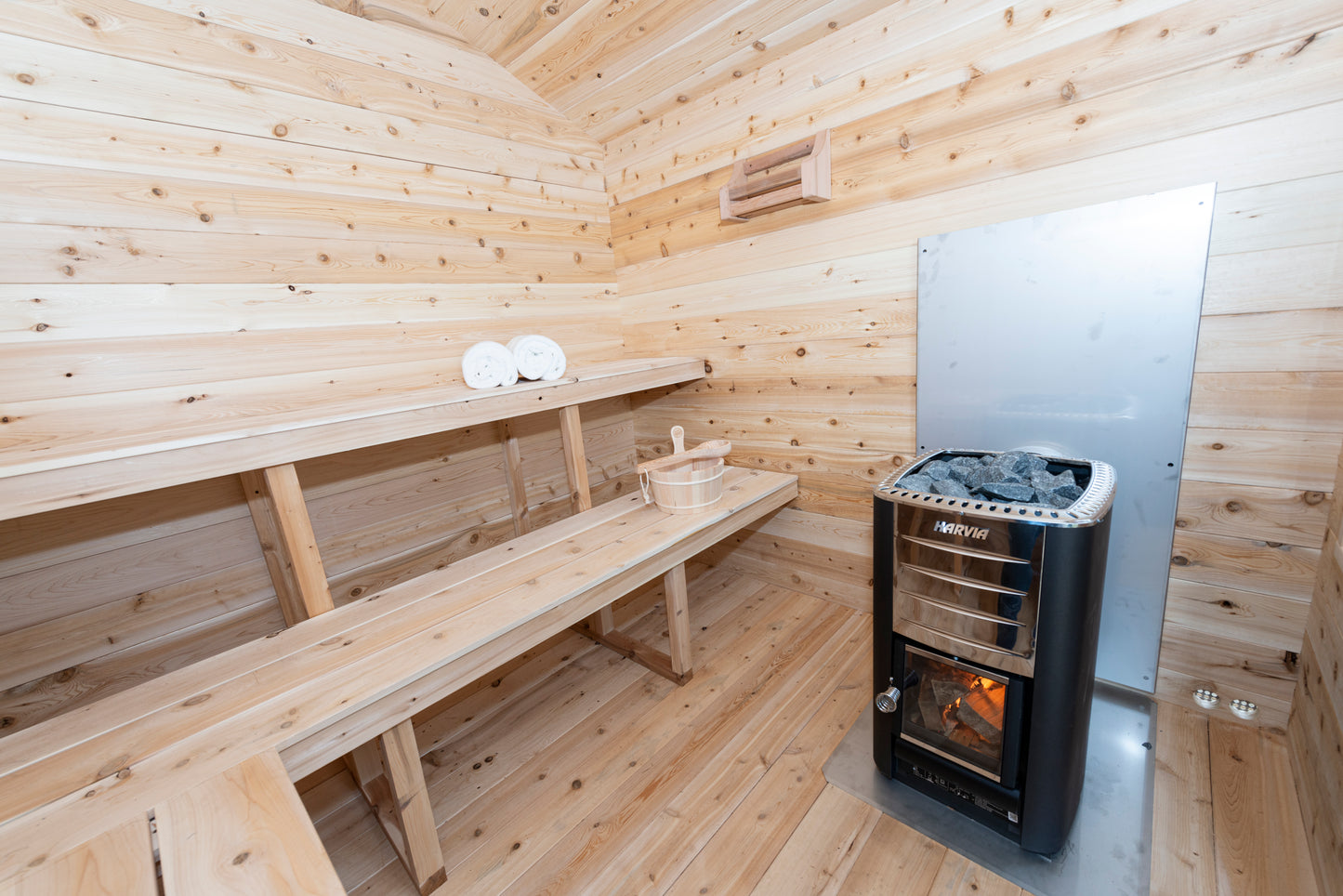 Wooden sauna with a stove and benches