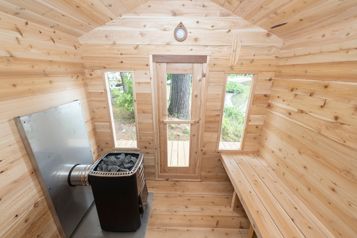 Wooden sauna interior with bench, door, and window