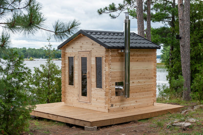 Wooden cabin by a lake with trees in the background
