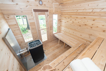 Wooden sauna interior with a metal sauna heater.