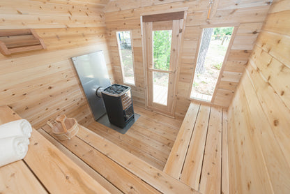 Wooden sauna interior with a stove and windows