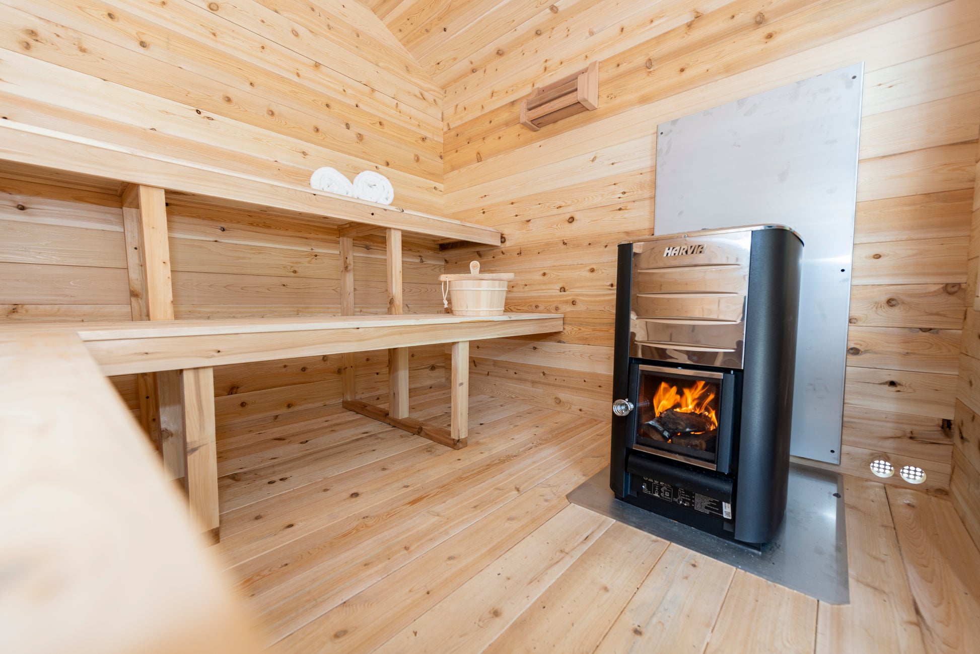 Wooden sauna with a stove and wooden bench