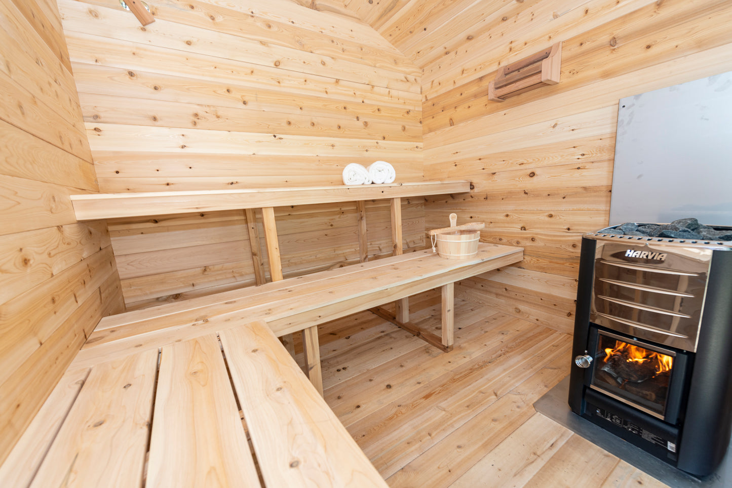 Wooden sauna with benches and a heater