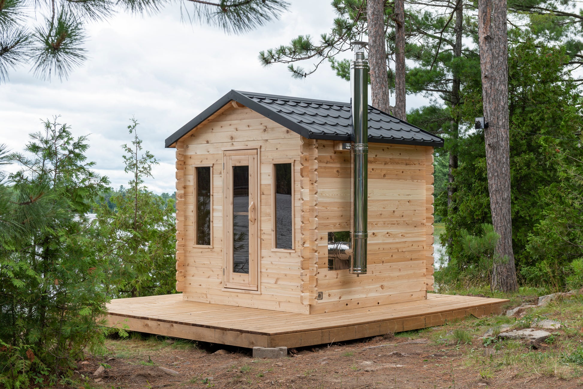 Wooden cabin with a chimney in a forest setting