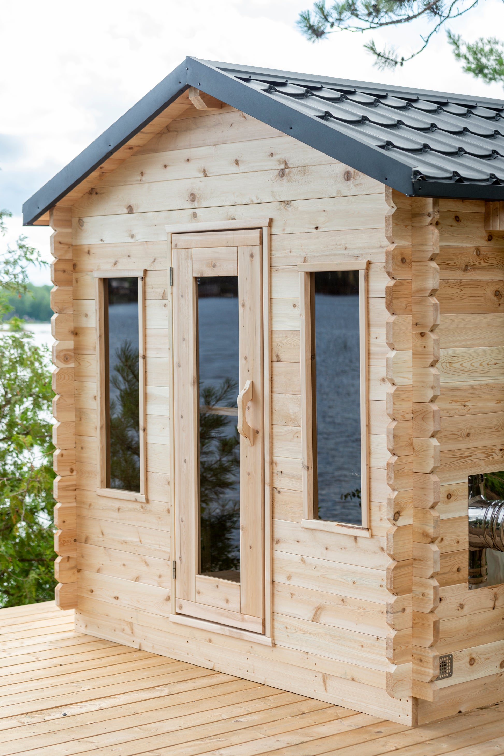 Wooden cabin with a view of water and trees