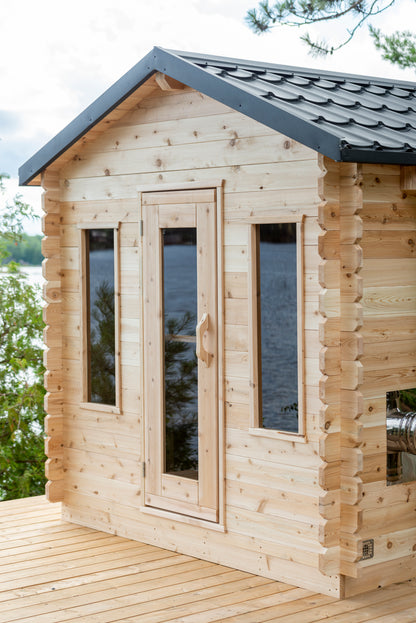 Wooden cabin with a view of water and trees