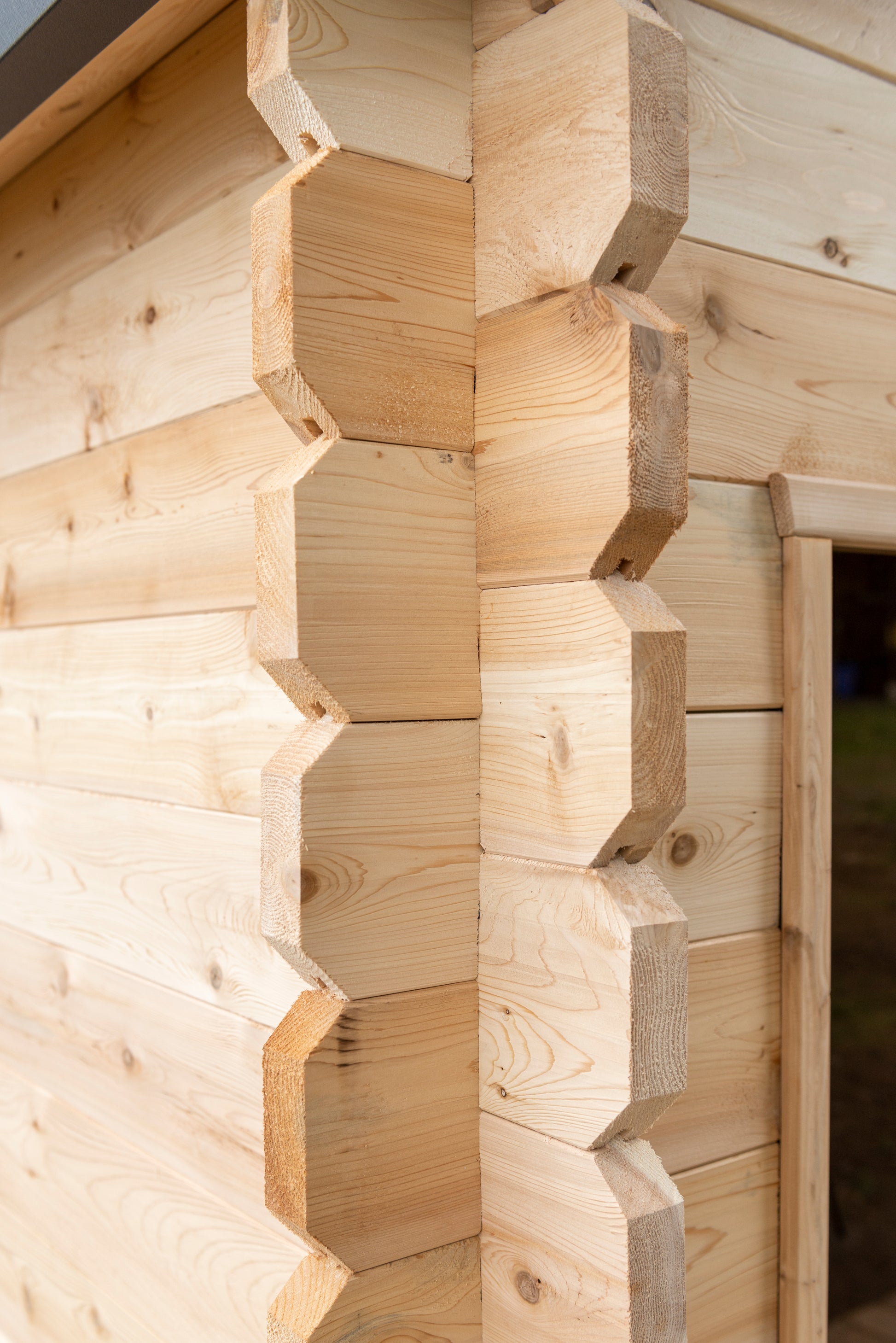 Close-up of a wooden cabin with geometric woodwork