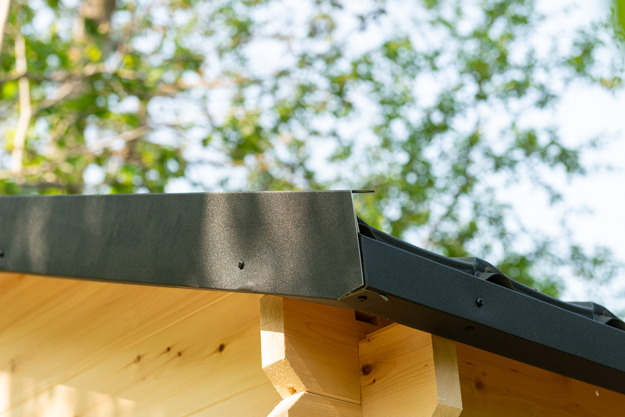 Wooden structure with metal bracket against a blurred green background
