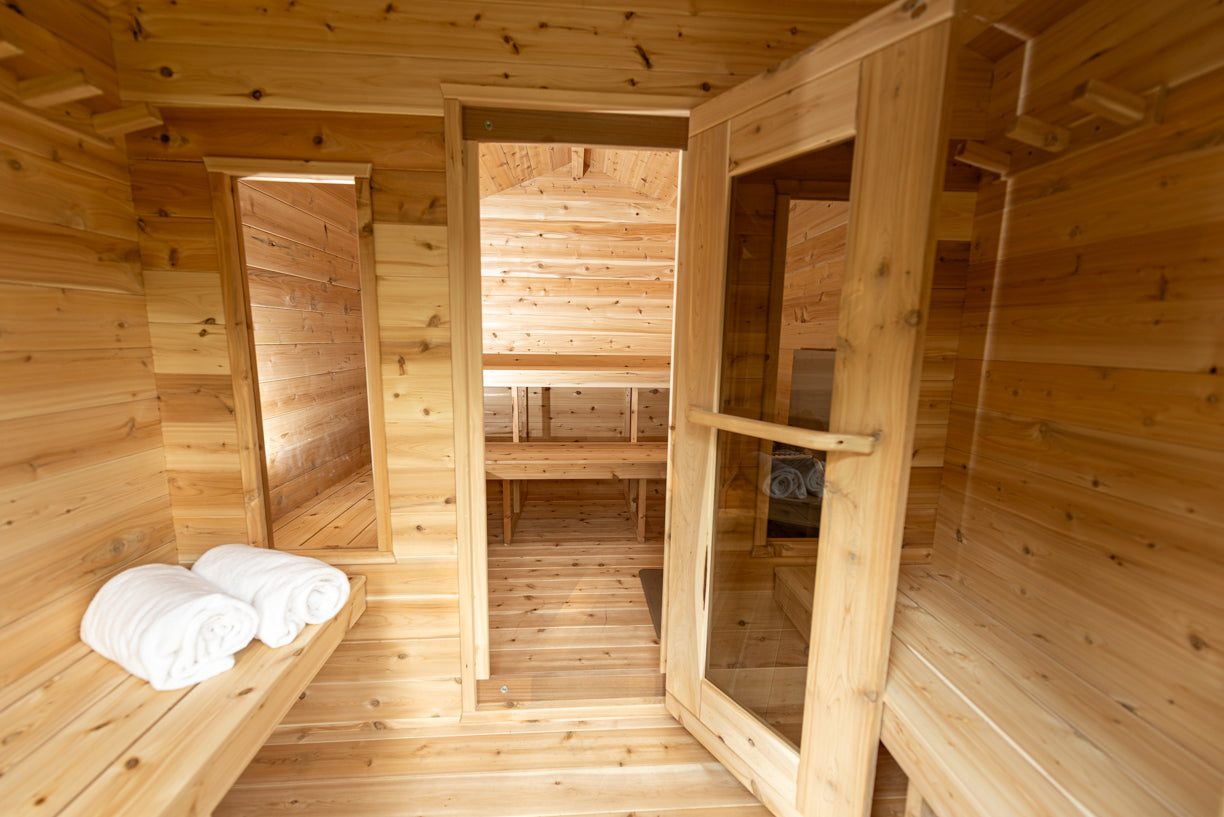 Wooden sauna interior with benches and towels