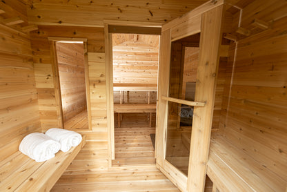 Wooden sauna interior with benches and towels
