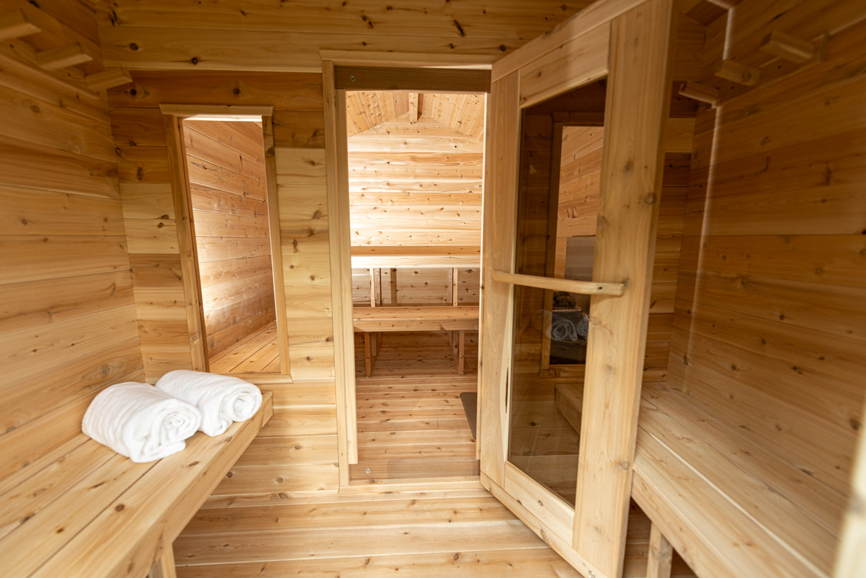 Wooden sauna interior with benches and towels