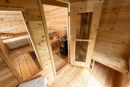Wooden sauna interior with benches and a door.