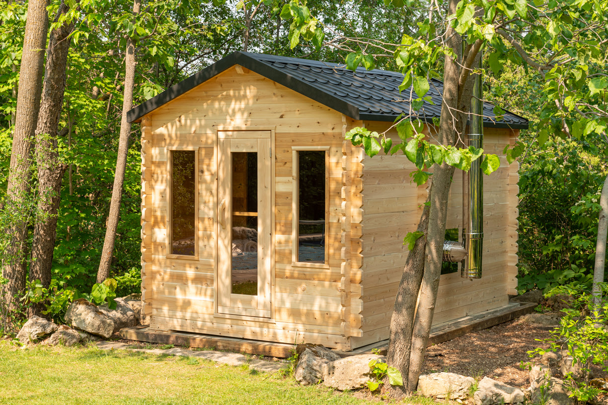Wooden cabin in a forest setting with greenery around