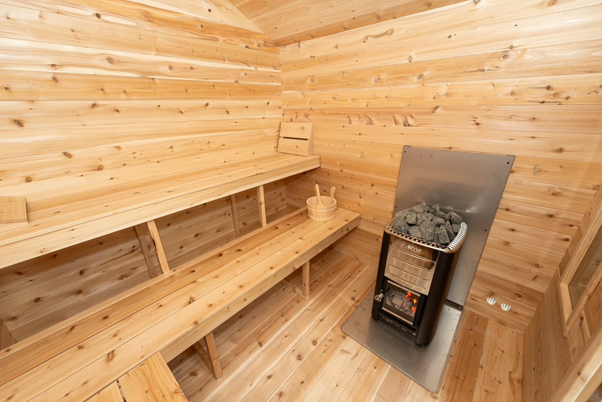 Wooden sauna interior with a bench and stove.