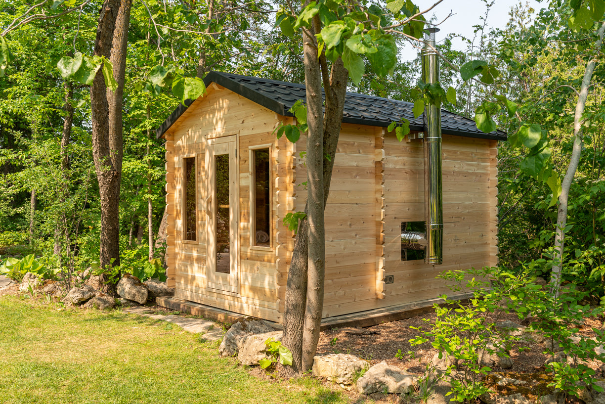 Small wooden cabin nestled among trees in a forest setting