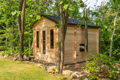 Small wooden cabin nestled among trees in a forest setting